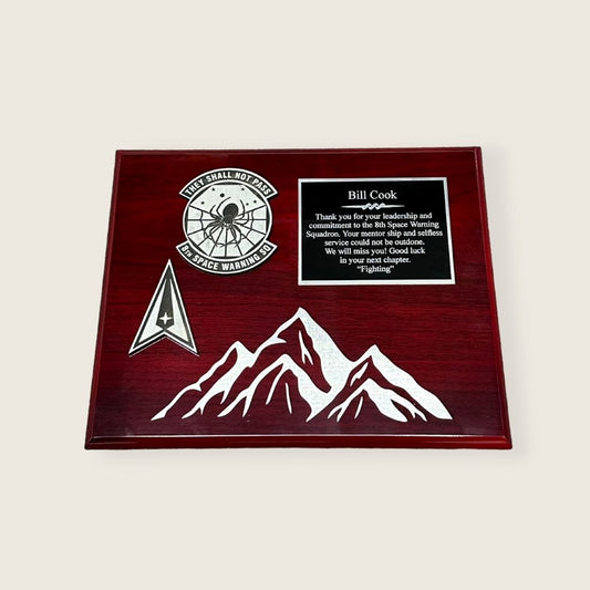 rosewood finish plaque with engraved mountains in a black and silver color scheme