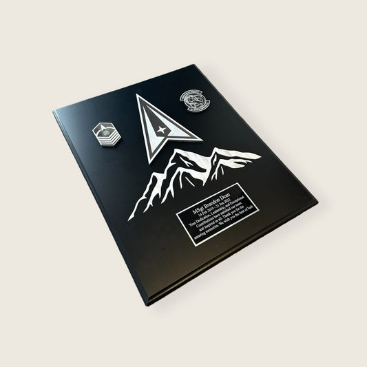 space plaque in black and silver color scheme with mountains side view