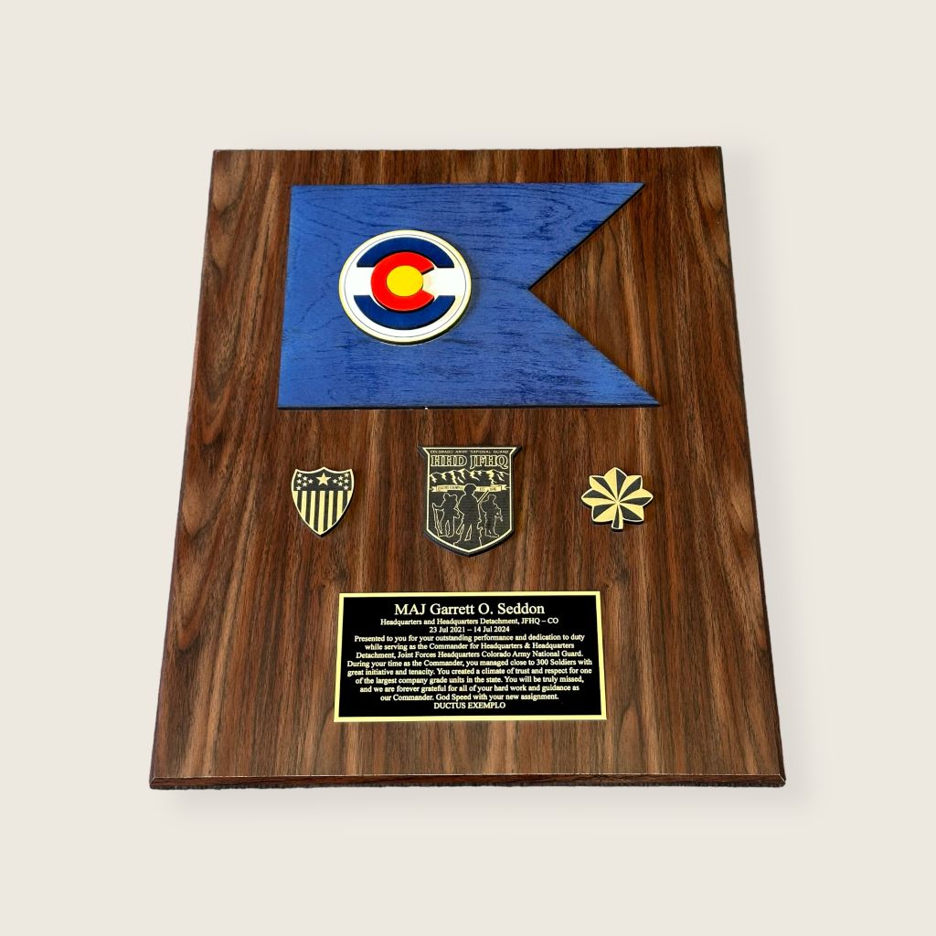 Walnut finish unit guidon plaque with 3 wood coins and a large engraved plate