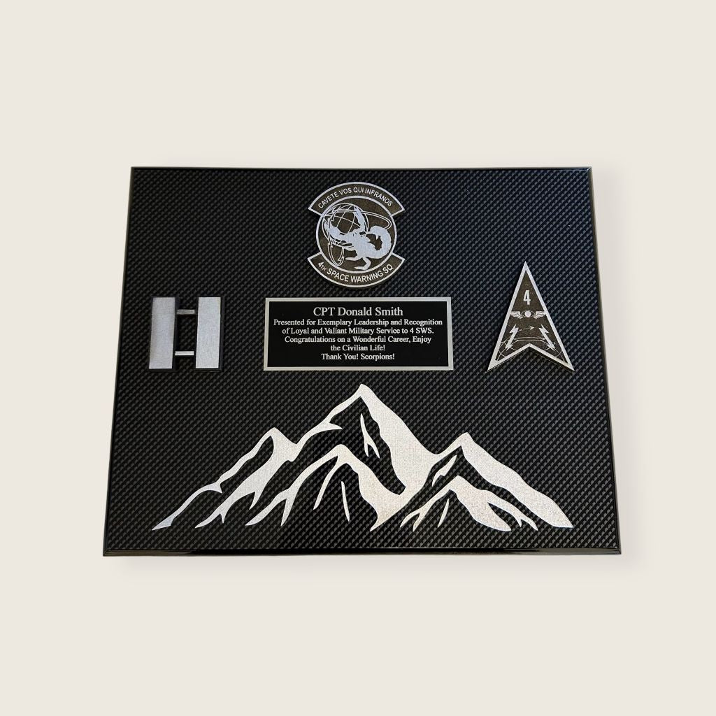 carbon fiber finish plaque with engraved mountains and black and silver color scheme