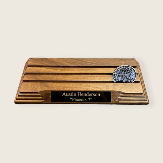 walnut coin rack with an engraved black and gold plate and a coin displayed